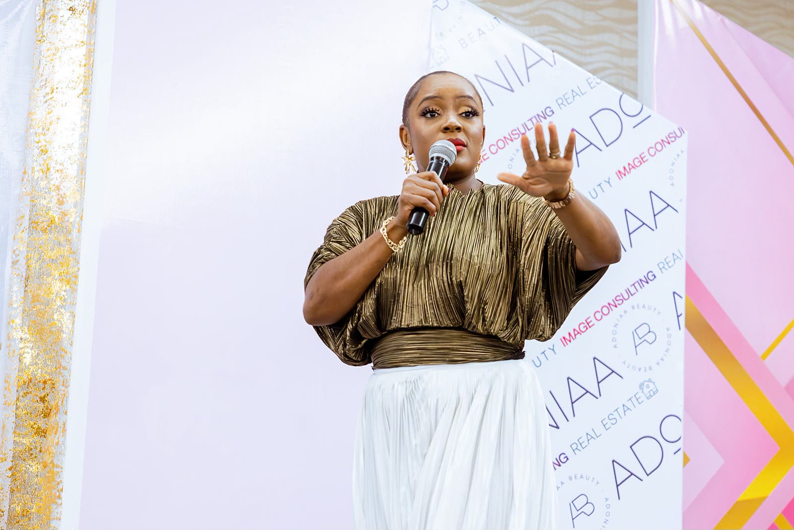 UYB speaker addressing women on stage at a live event